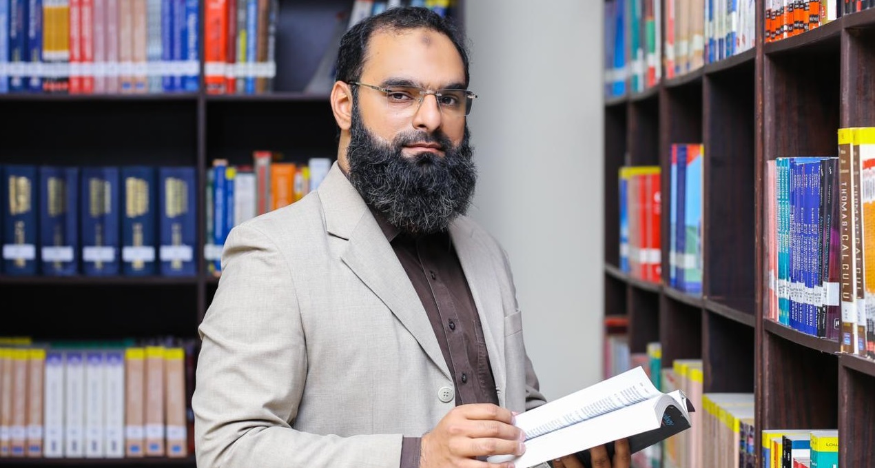 Dr. Kamal Shahid in a library